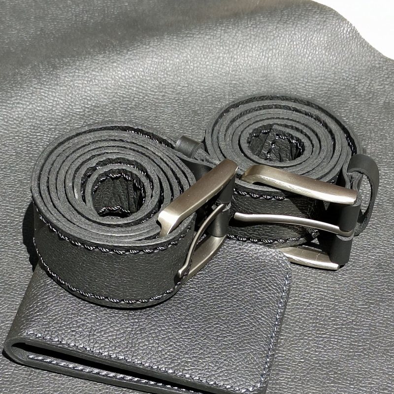 Black leather belts with grey stitching and metal buckles