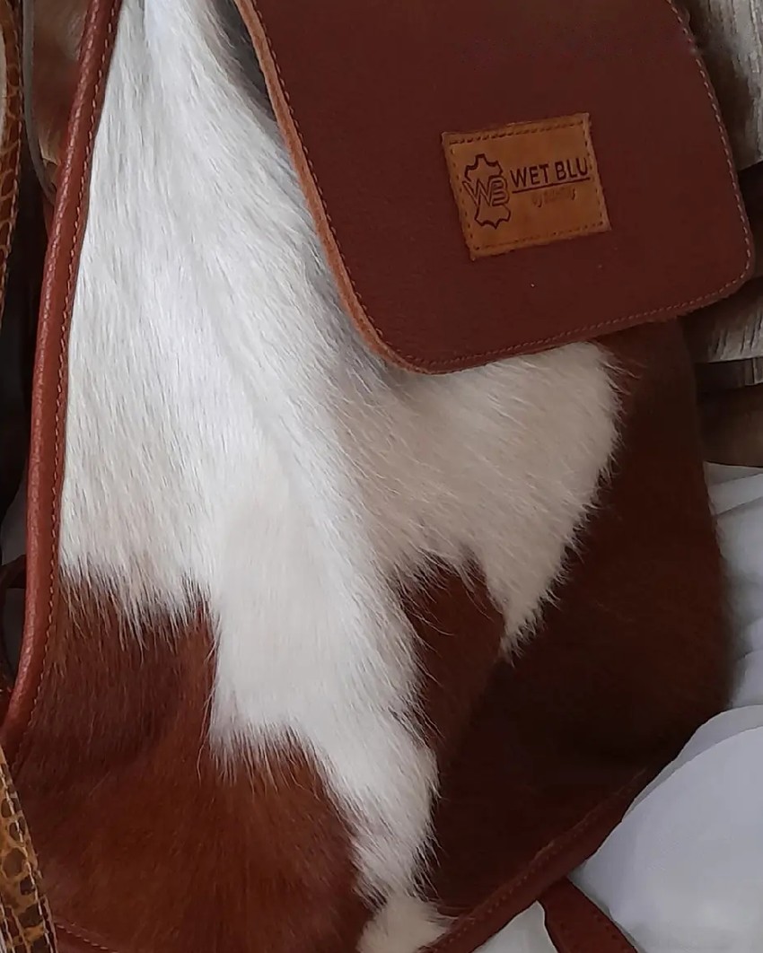 Safari backpack with smooth brown leather flap and cowhide body
