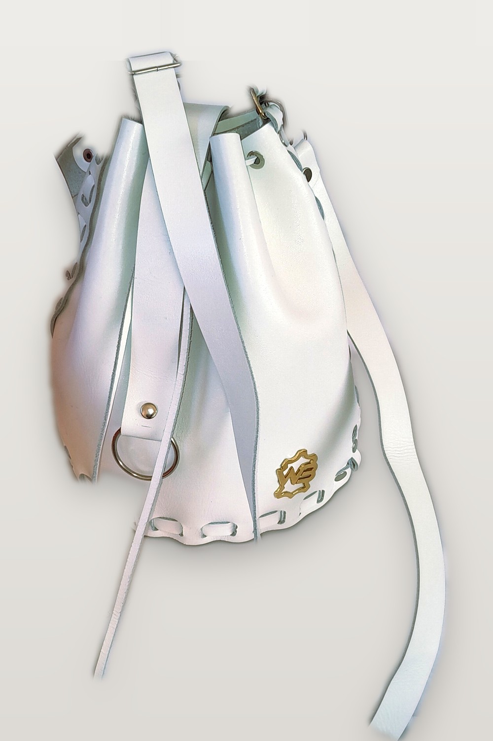 SiRi white leather bucket bag with whipstitched edges and a gold WB badge