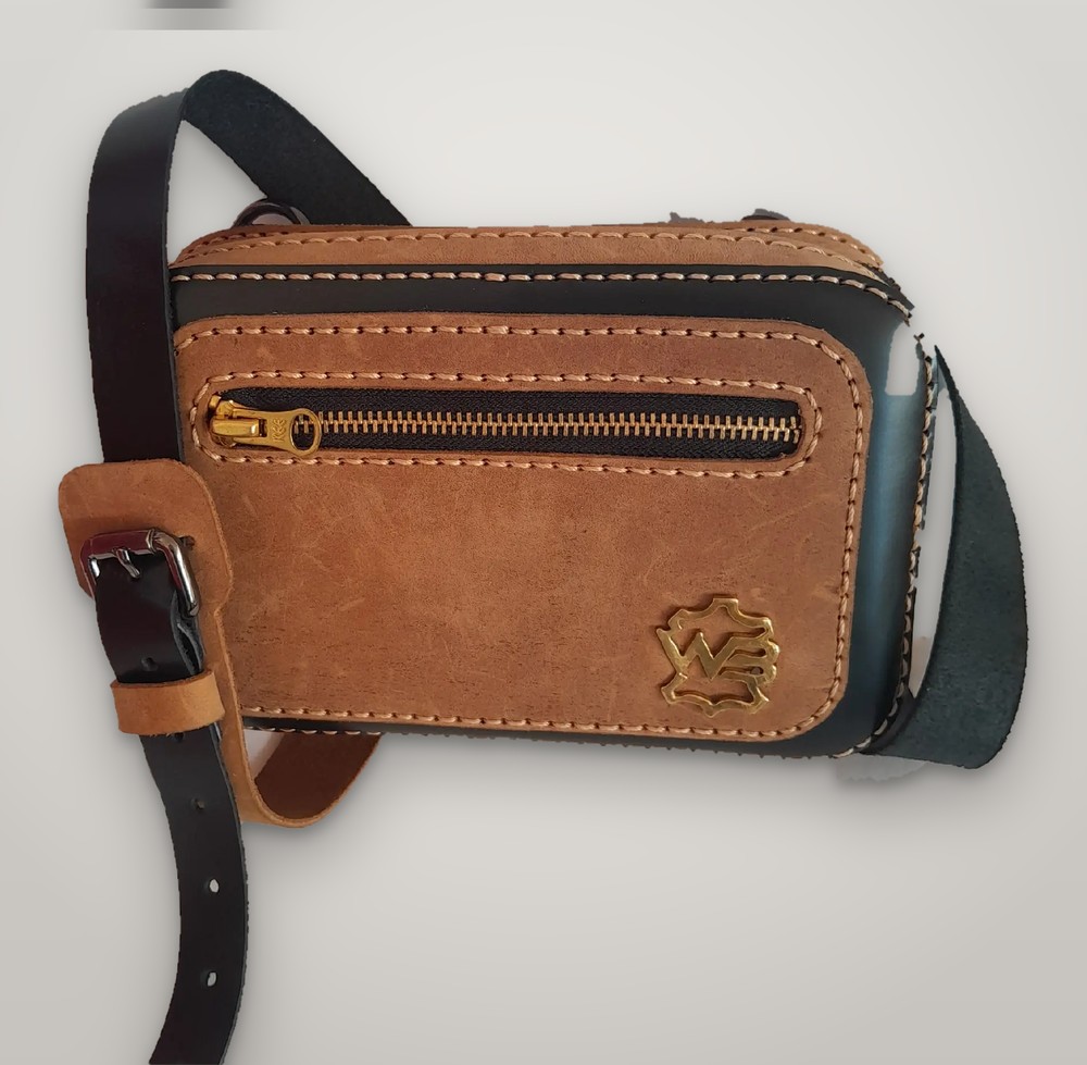 Slinger tan leather sling bag with brass zip pocket, gold WetBlu badge and black strap