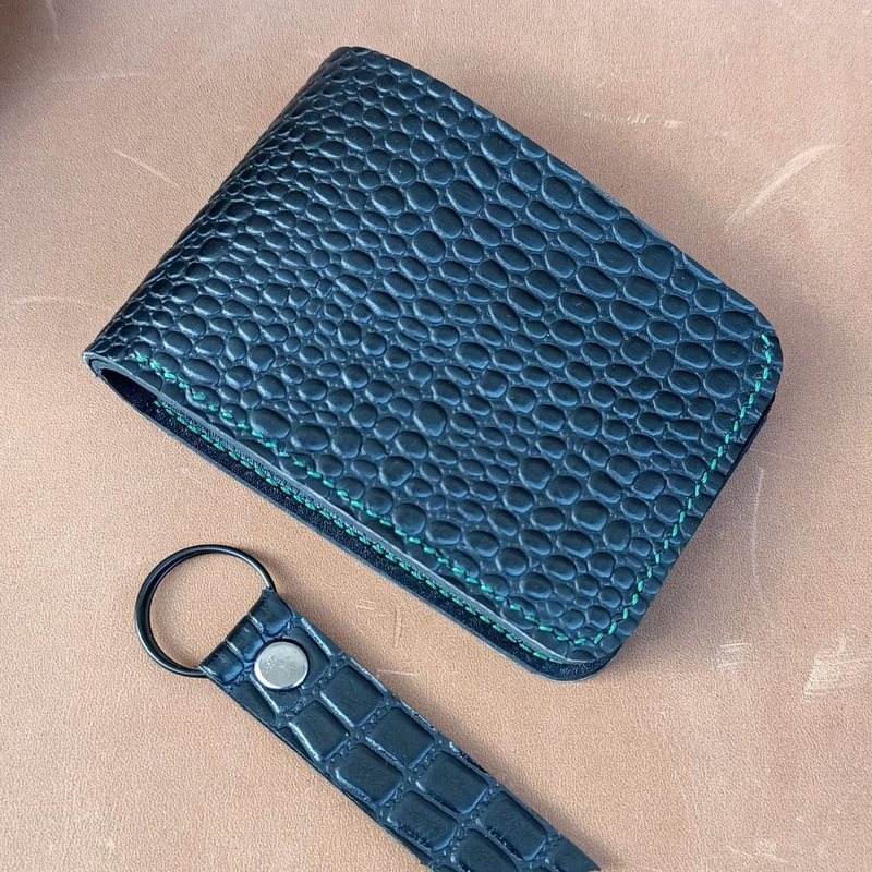 Black croc-embossed leather wallet with green stitching