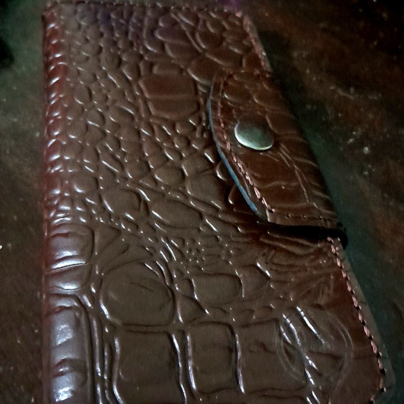 Brown croc-embossed leather wallet with snap closure